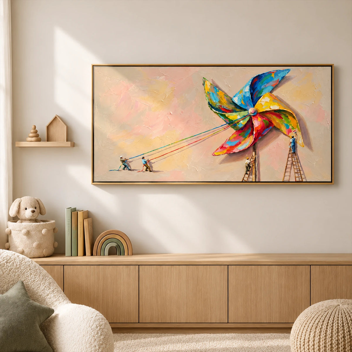 Pinwheel Makers artwork displayed above wooden cabinetry in a softly furnished playroom.