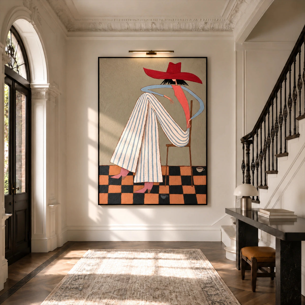 Scarlet Poise artwork displayed beside a staircase beneath a picture light.