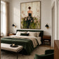 Blossom Reverie artwork displayed above a bed with dark green bedding.