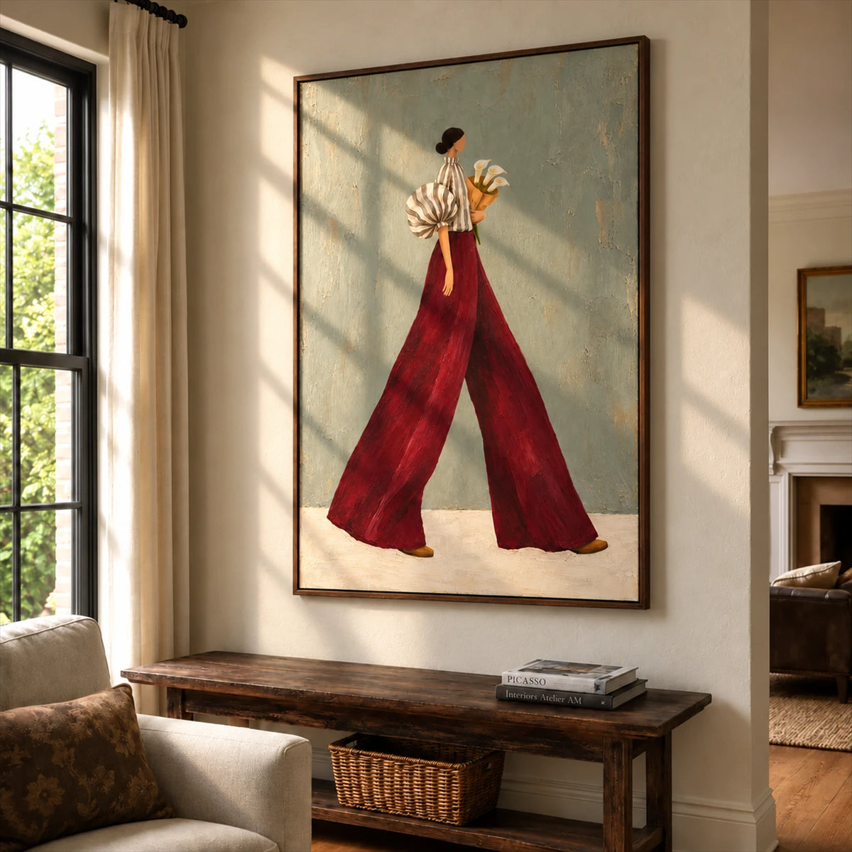 Garnet Stride artwork displayed above a wooden console beside a window.