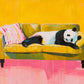 Panda Pause full artwork. A panda stretches lazily across an olive-green sofa beside a striped pink cushion.