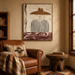 Umber Brim artwork displayed above a leather armchair in a rustic reading corner.