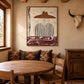 Umber Brim artwork displayed beside a round wooden dining table.