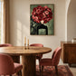 Rose Sovereign artwork displayed above a round dining table with pink chairs.