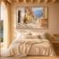 Coastal Descent artwork displayed above a bed with cream linens.