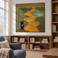 Golden Wanderer artwork displayed above a low bookcase in a reading nook.