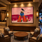 Raven Interlude artwork displayed above a cabinet behind a round lounge table.