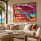 Parasol Escape artwork displayed above a cream sofa beside a coastal window.
