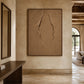 Earthen Fissure artwork displayed above a console in a stone entryway.