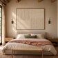 Ivory Quadrants artwork displayed above a bed with neutral linens.