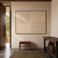 Ivory Quadrants artwork displayed above a wooden bench beside an open doorway.