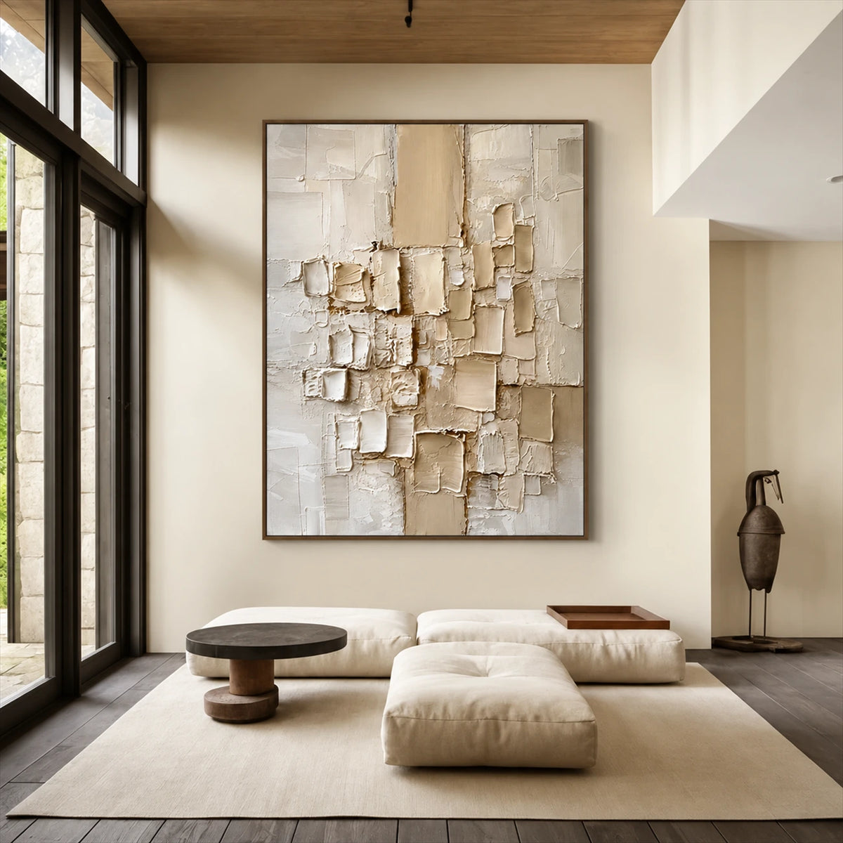 Ivory Strata artwork displayed above low seating beside tall windows.
