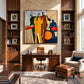 Syncopated Hues artwork displayed above a desk between built-in bookshelves.