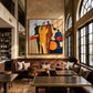 Syncopated Hues artwork displayed above leather seating in a high-ceilinged lounge.