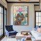 Fuchsia Reverie artwork displayed above a blue armchair and pale sofa.