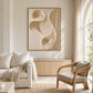 Sculpted Current artwork displayed above a cabinet beside cream seating.