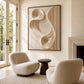 Sculpted Current artwork displayed above rounded lounge chairs near a fireplace.