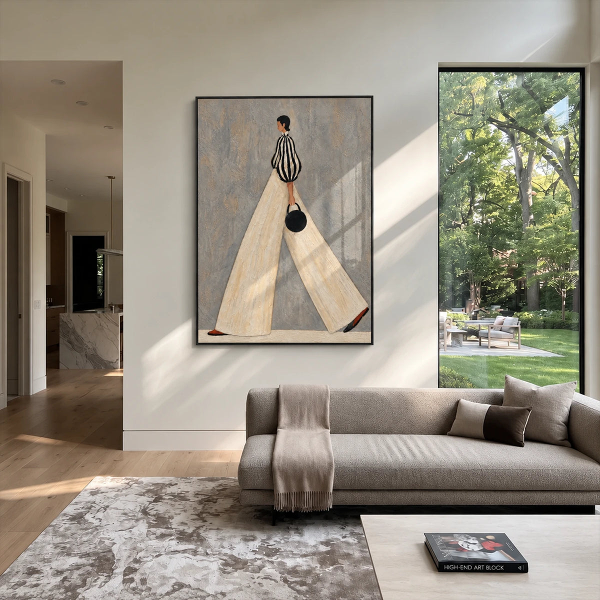 Ivory Stride artwork displayed beside a gray sofa facing a garden.