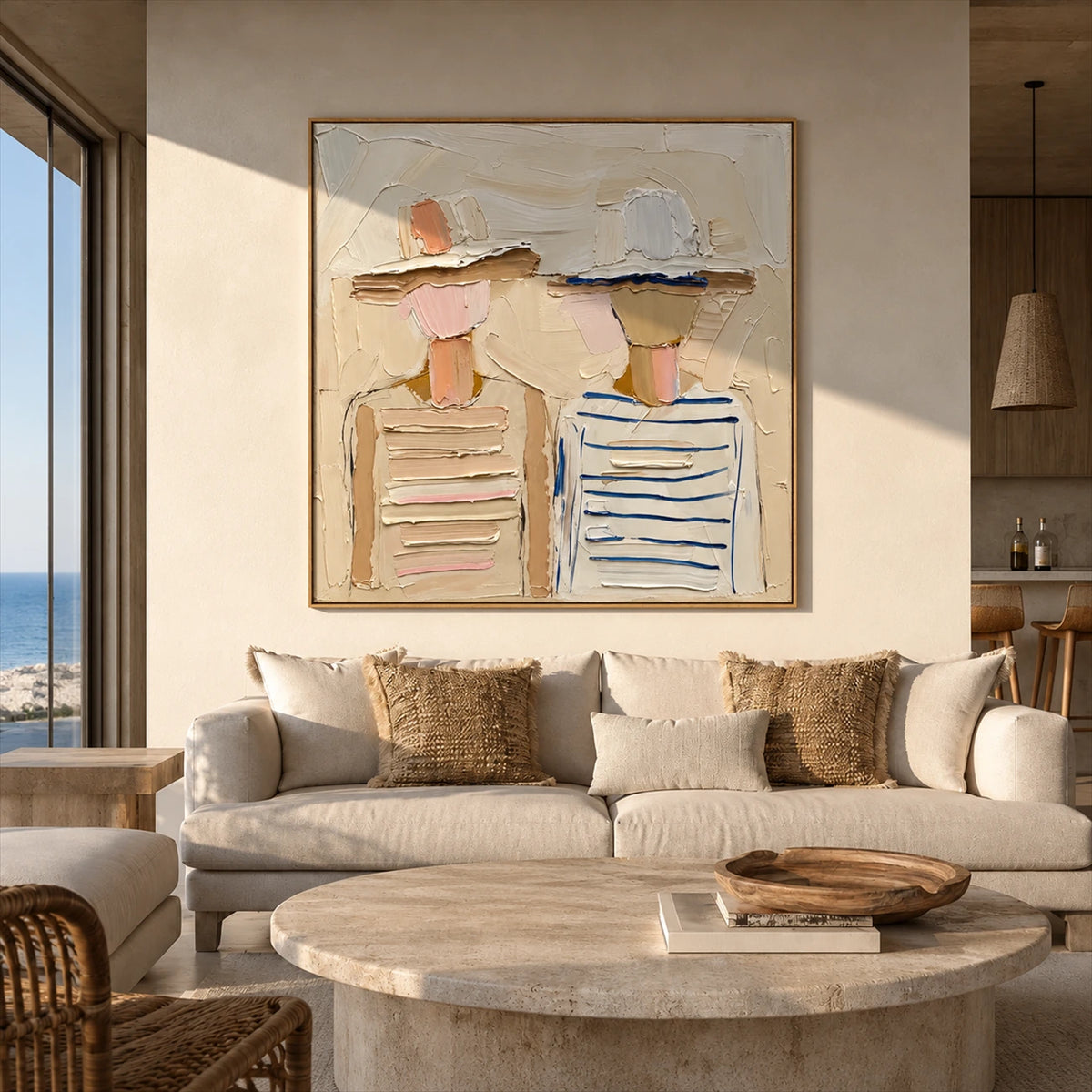 Sunhat Companions artwork displayed above a cream sofa in a coastal room.