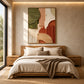 Terracotta Contours artwork displayed above a bed with neutral linens.