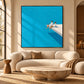 Turquoise Leisure artwork displayed above a curved cream sofa.