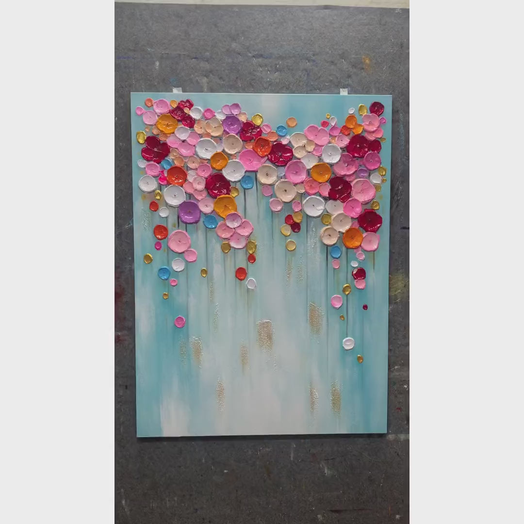 Bloom Cascade Wall Art hand-painting process — an artist builds colorful raised floral petals and gold accents on a pale turquoise canvas.