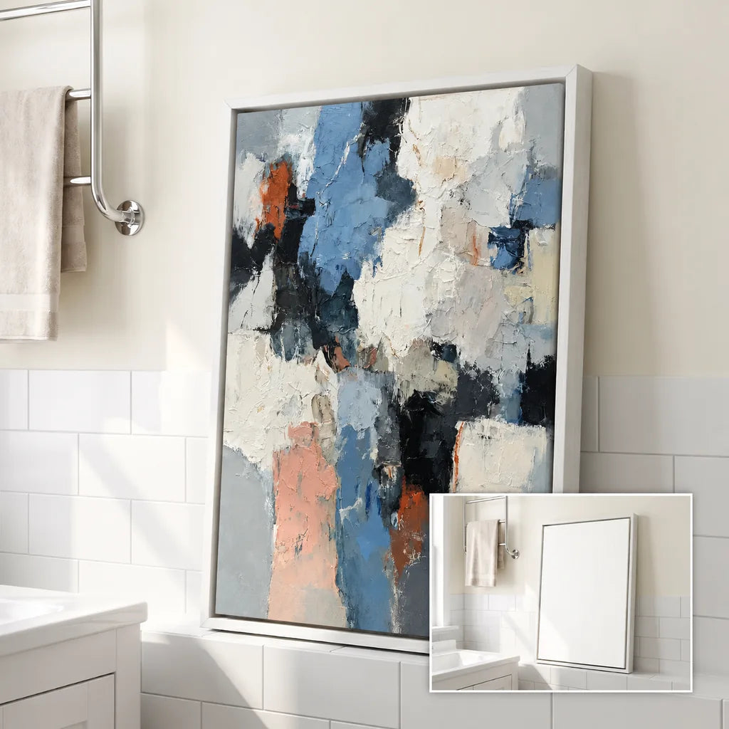 Blue, white and charcoal abstract painting in a light frame displayed in a sunlit bathroom.